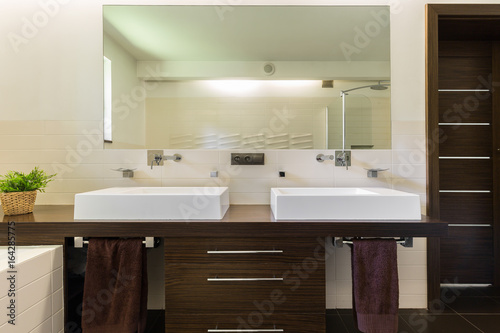 Modern bathroom with dark furniture