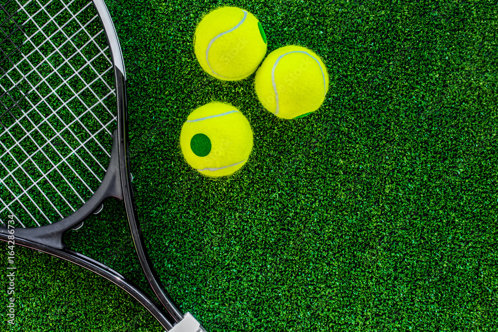 tennis racket on green background top view