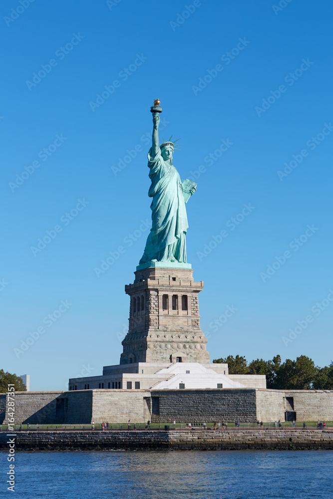 Statue of Liberty and Liberty Island in a sunny day, blue sky in New York