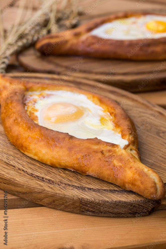 Two Georgian khachapuri close-up on the table Two Georgian khachapuri close-up on the table