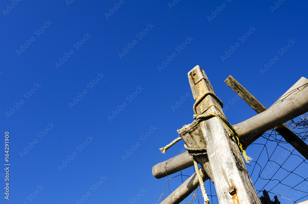 bottom to top view of wooden hut at sunny day over blue sky background