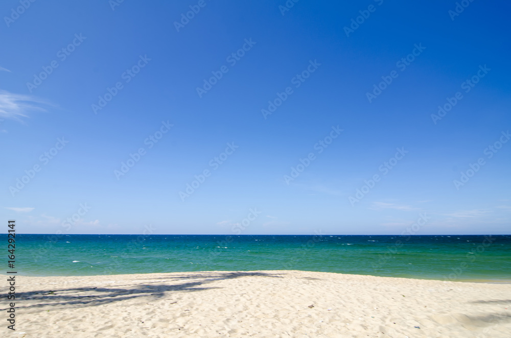 tropical sandy beach at sunny day.blue sky and torquise sea water. ideal for travel and vacation background tropical sandy beach at sunny day.blue sky and torquise sea water. ideal for travel and vacation background