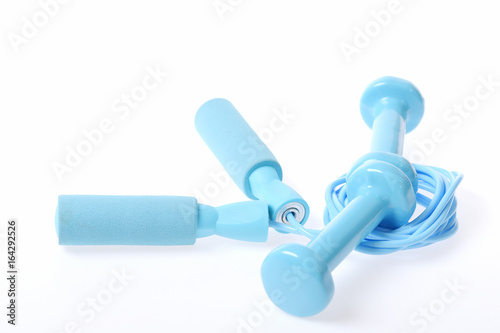 Artistic composition made out of cyan dumbbells and skipping rope