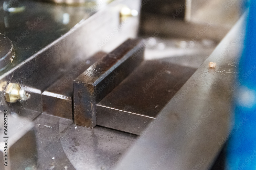 The face milling tool with the raw material work piece on the CNC milling machine.The spindle with holder and tooling for face milling on CNC milling machine. Selective focus The face milling tool with the raw material work piece on the CNC milling machine.The spindle with holder and tooling for face milling on CNC milling machine. Selective focus
