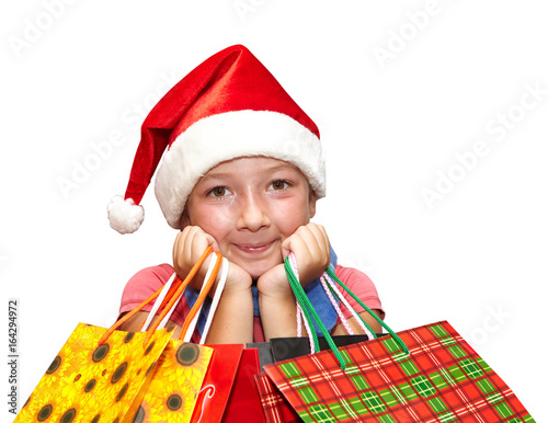 Little girl in red cap with shopping bags. Christmas