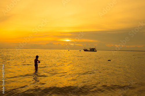 people on the beach during sunset time or silhouette