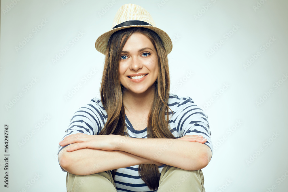 Fototapeta premium Smiling young woman sitting with folded hands.