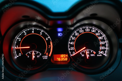 Speedometer of a car with high lamp on