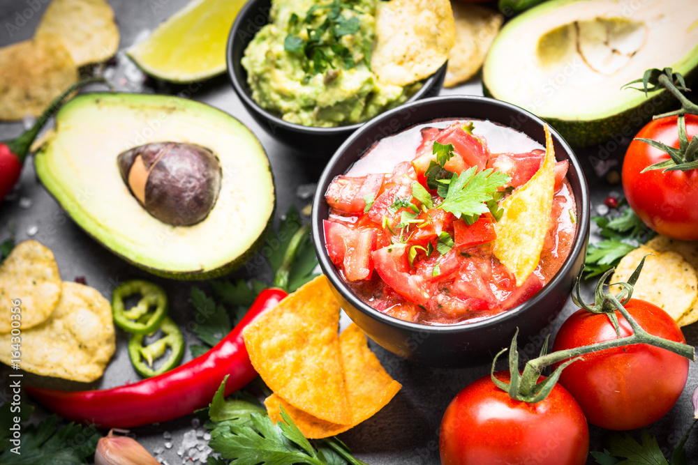 Latinamerican food party sauce guacamole, salsa, chips and ingre Latinamerican food party sauce guacamole, salsa, chips and ingre