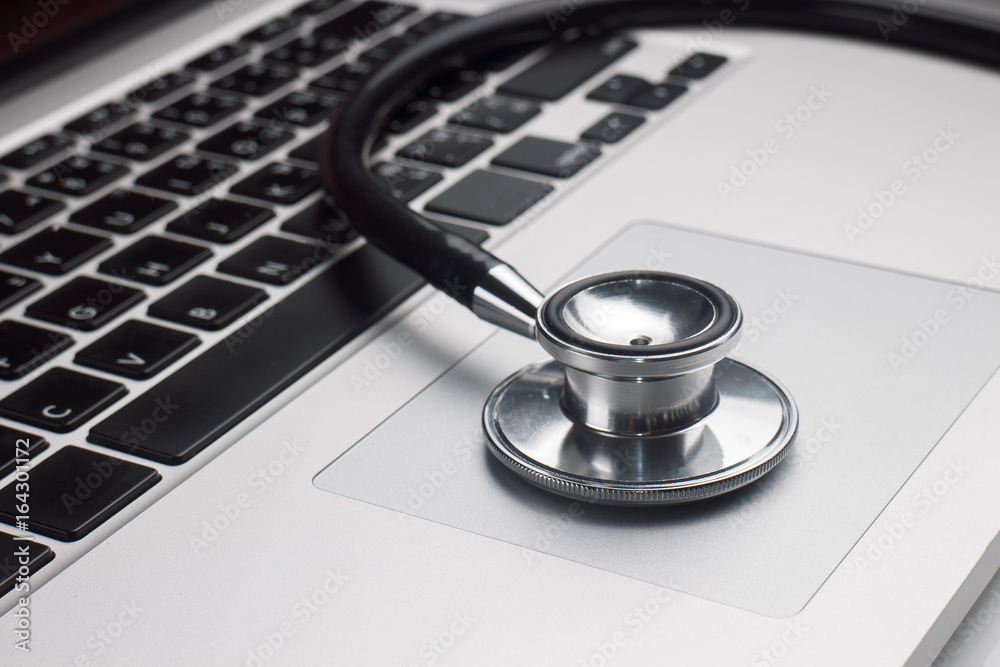 Stethoscope on Computer Laptop keyboard, Computer Health check Concept Stethoscope on Computer Laptop keyboard, Computer Health check Concept