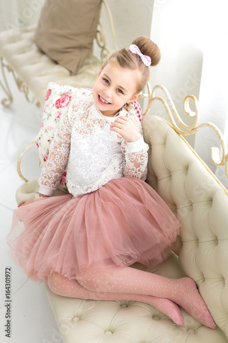 Portrait of a beautiful smiling little girl in the studio