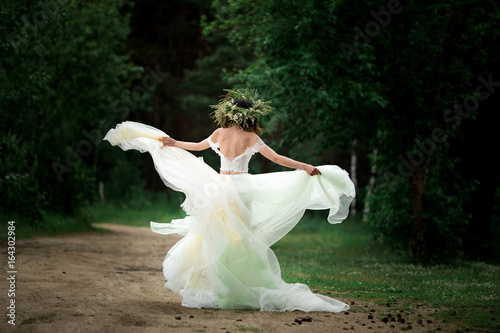 The bride is spinning in her wedding dress