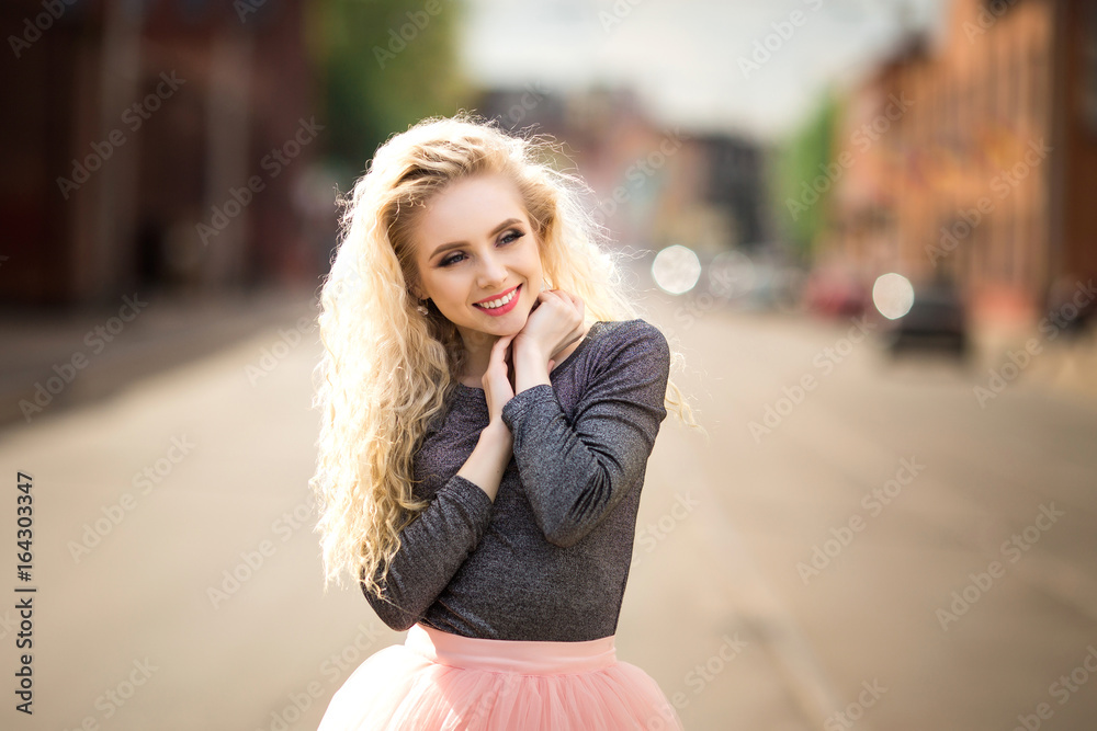 A beautiful girl is walking along the street. A beautiful girl is walking along the street.