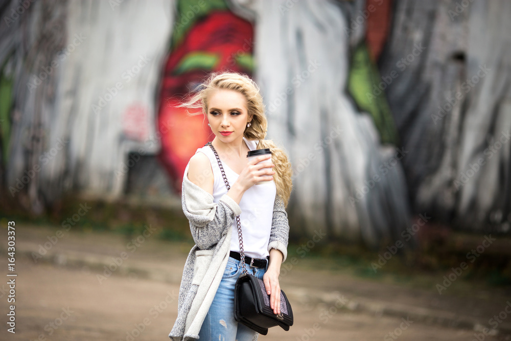 Beautiful sad girl drinking coffee on the street Beautiful sad girl drinking coffee on the street