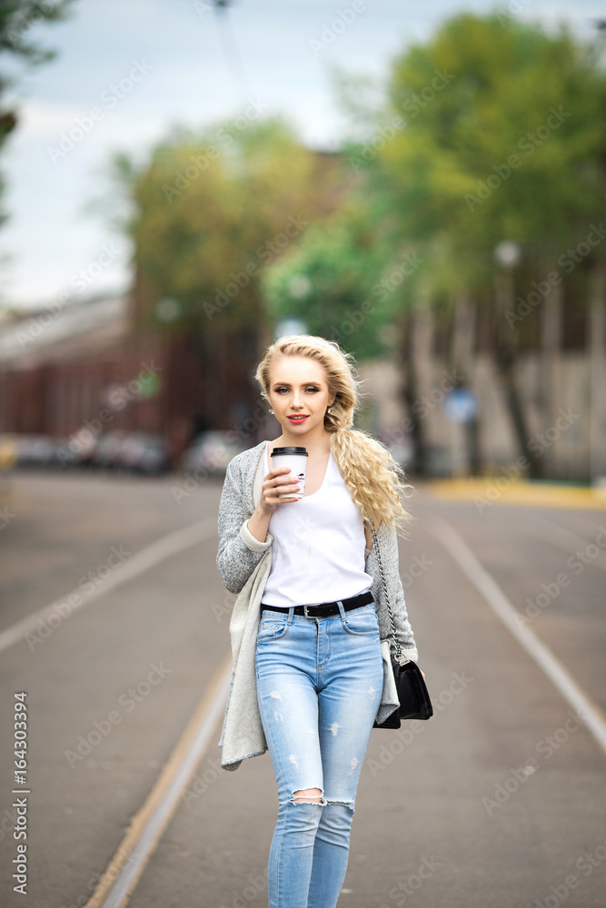 Beautiful sad girl drinking coffee on the street Beautiful sad girl drinking coffee on the street