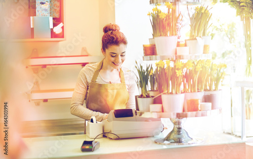 florist woman at flower shop cashbox on counter