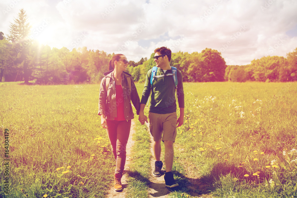 happy couple with backpacks hiking outdoors happy couple with backpacks hiking outdoors