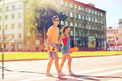 teenage couple with skateboards on city street © Syda Productions