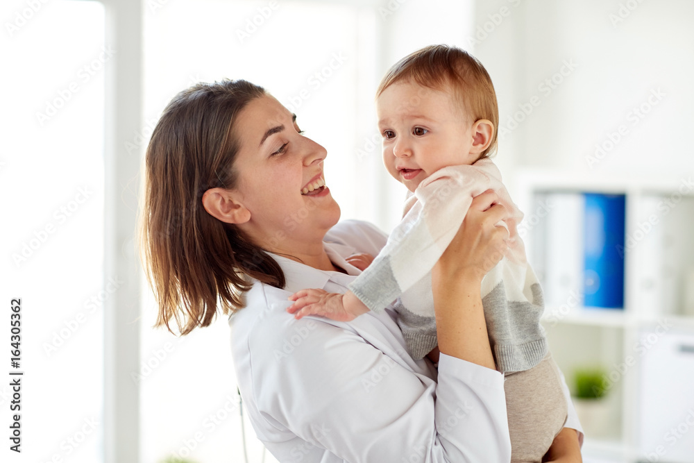 happy doctor or pediatrician with baby at clinic happy doctor or pediatrician with baby at clinic