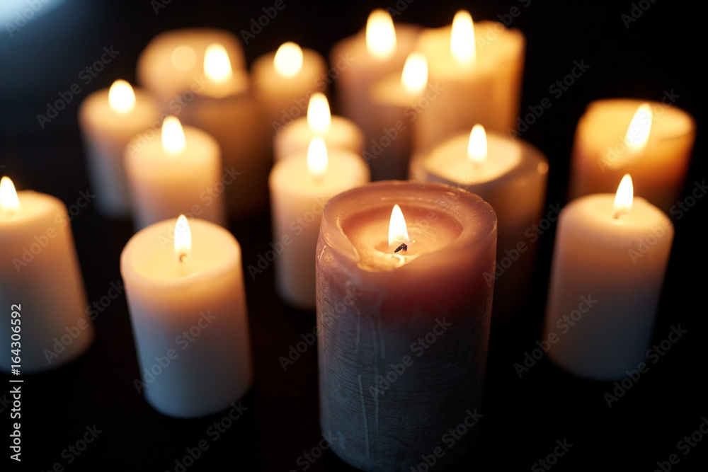candles burning in darkness over black background candles burning in darkness over black background