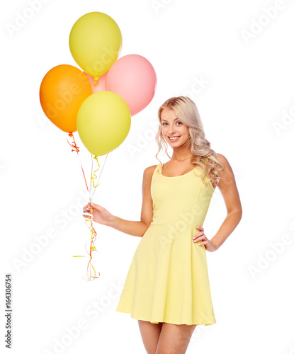 happy woman in dress with helium air balloons