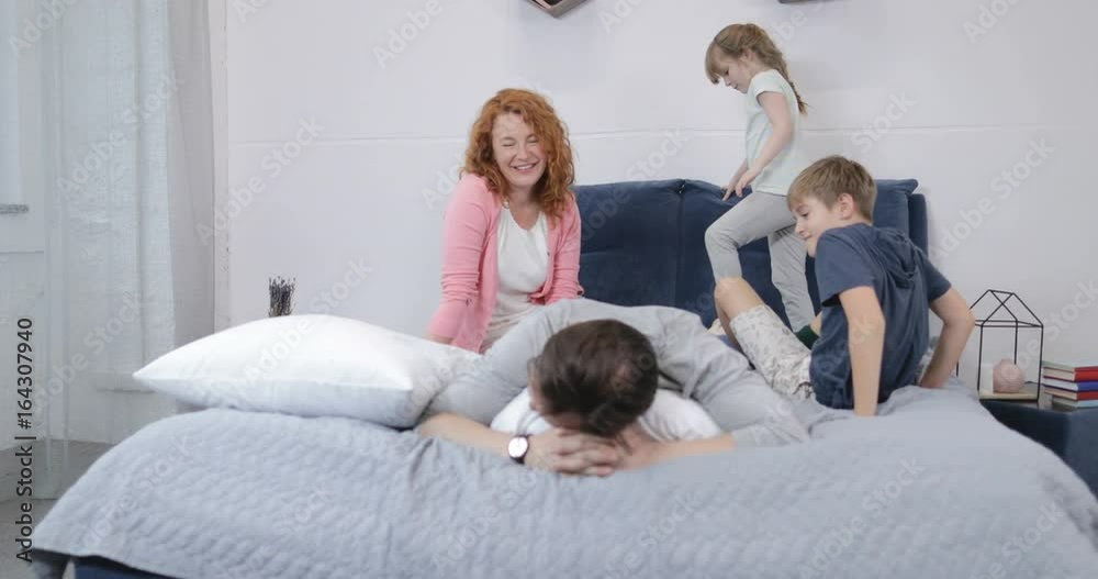 Happy Smiling Family Having Fun In Bedroom Lying Together On Father On Bed In Morning Slow Motion 60 Happy Smiling Family Having Fun In Bedroom Lying Together On Father On Bed In Morning Slow Motion 60