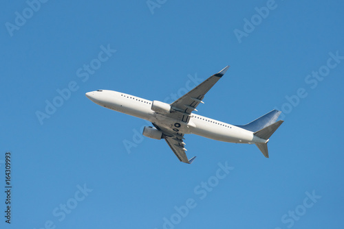 Airplane flying away in to sky high altitude above the white clouds, Airplane taking off, Travel by air transport