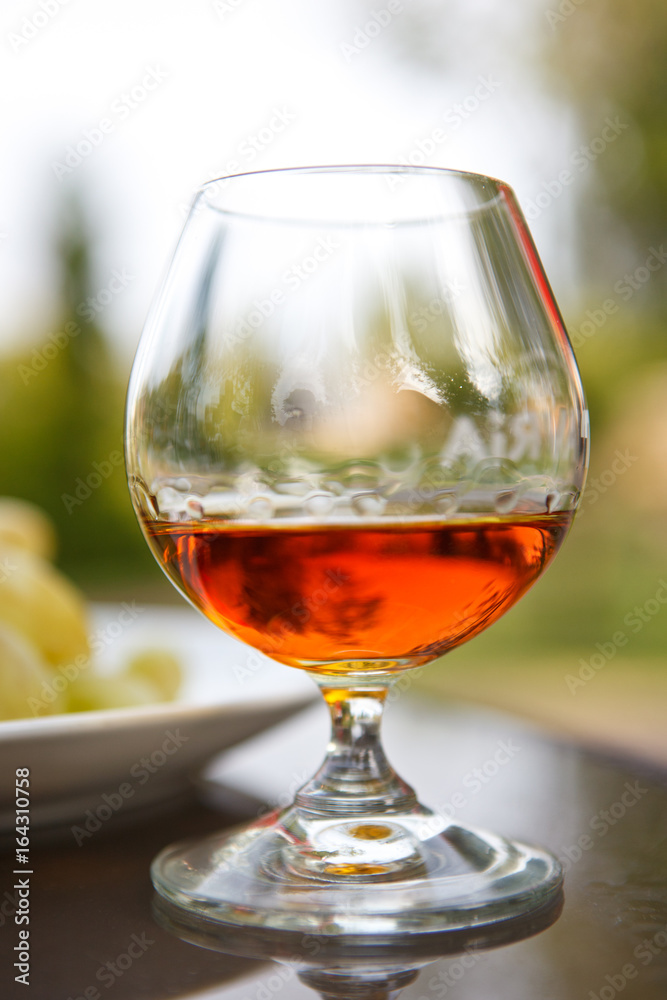 Cognac in a glass with grapes Cognac in a glass with grapes