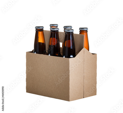 фотография Six pack of glass bottled beer in generic brown cardboard carrier isolated on wh