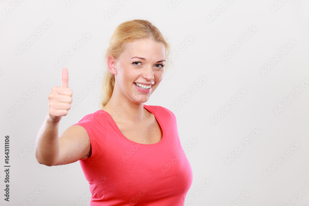 Fototapeta premium Happy woman showing thumbs up gesture