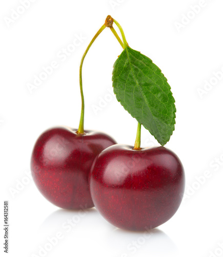 Ripe cherries fruits with green leaves isolated on white