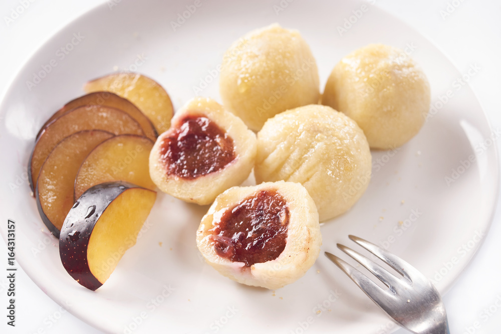 Austrian traditional dumplings filled with plum on white Austrian traditional dumplings filled with plum on white