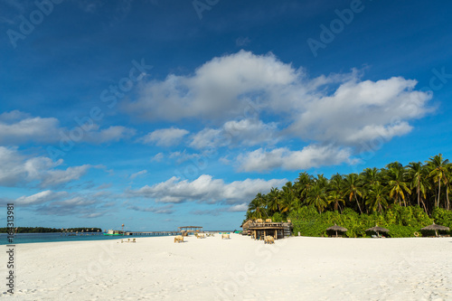 Tropical beach. Ocean waves and cloudy sky background. White sand and crystal-blue sea. Ocean water nature, beach relax. Summer sea vacation. Maldives islands sea background © gawriloff