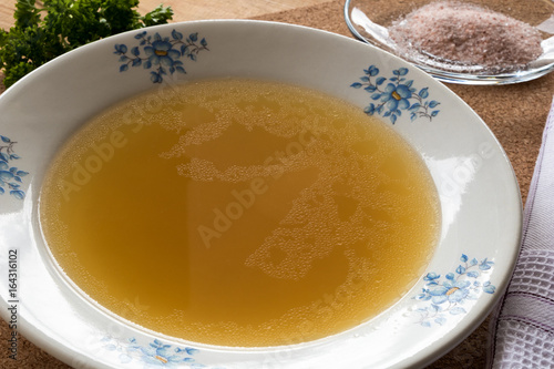 Bone broth made from chicken served in a plate