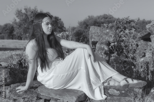 Young woman sitting on some old ruins. photo