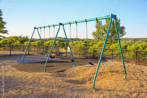 Empty chain swings in playground. Swing set at the park