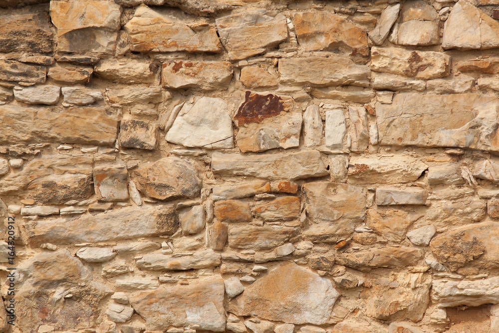 The detail, close up of the sandstone brick wall. The texture of the sandstone. It can be useld as the background. The detail, close up of the sandstone brick wall. The texture of the sandstone. It can be useld as the background.