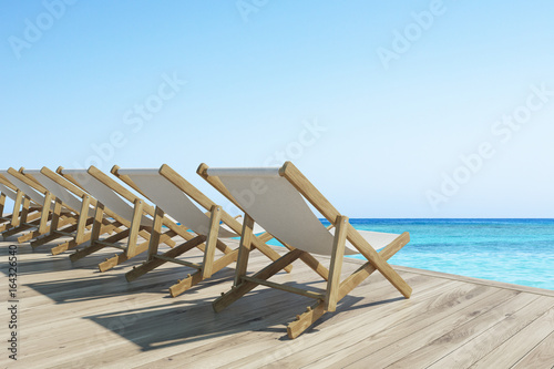 Wooden pier with a row of deck chairs