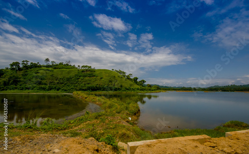 Lake in in the coast of Same, surrounded with abundat vegetation in a sunny day in the Ecuadorian coasts