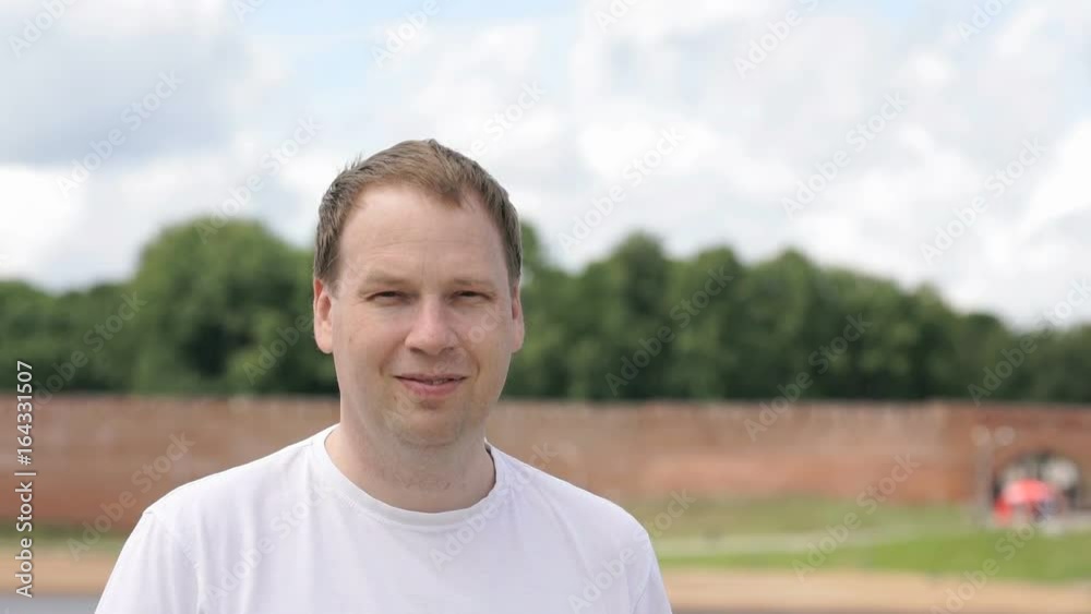 Portrait of serious young man aged 40s outdoors. Slow Motion