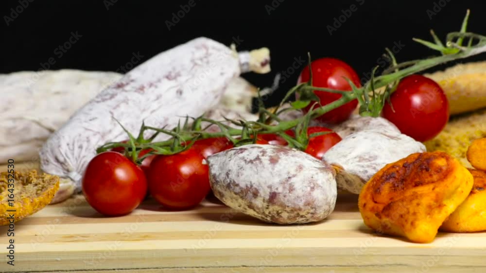 Chopping Board, delicious cured meat and pachino's tomatoes, bakery product Chopping Board, delicious cured meat and pachino's tomatoes, bakery product