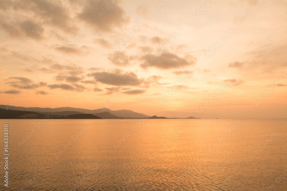 Sunset at sea  with brown and gold sky  and island landscape background,Koh Samui ,Thailand