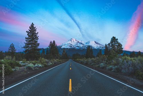 Sun setting on the road in the mountains 