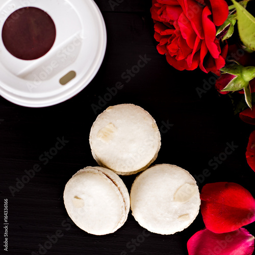 Classic French macaroons on a black background