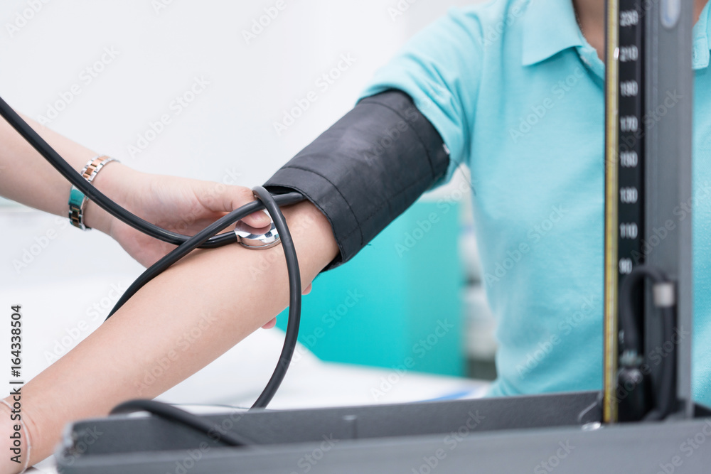 Nursing students are training measurement of blood pressure with sphygmomanometer at nursing school.