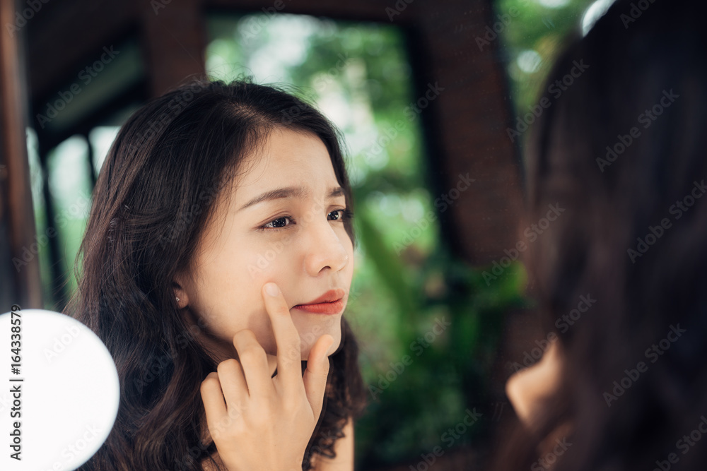 Beauty, skin care lifestyle concept. Young asian woman with acne looking at the mirror. Beauty, skin care lifestyle concept. Young asian woman with acne looking at the mirror.