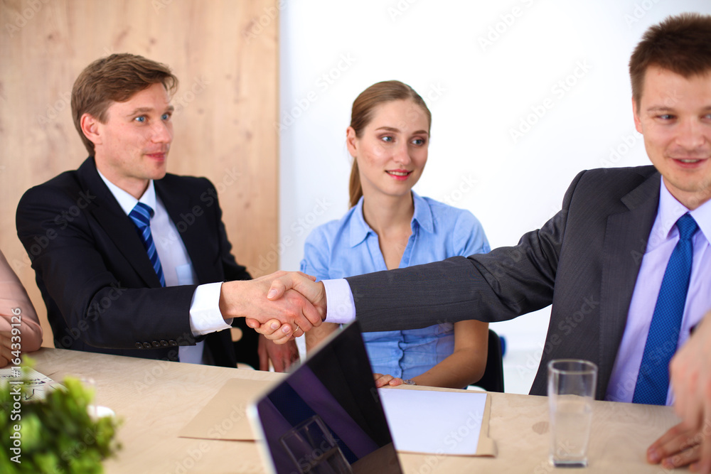Business meeting - manager discussing work with his colleagues Business meeting - manager discussing work with his colleagues