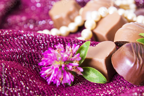 Assortment of chocolates and pearl necklace