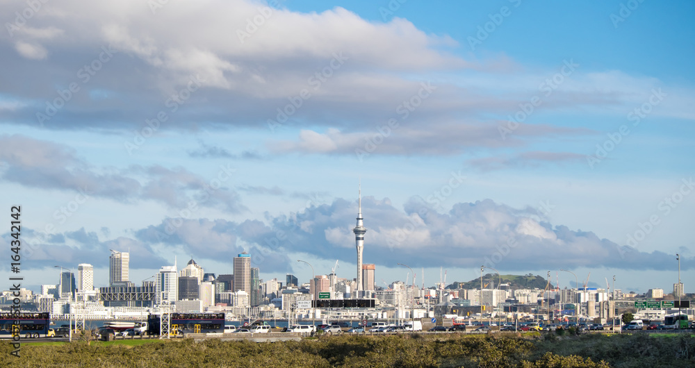 Traffic on Northern motorway with Auckland skyline in background, New Zealand, NZ