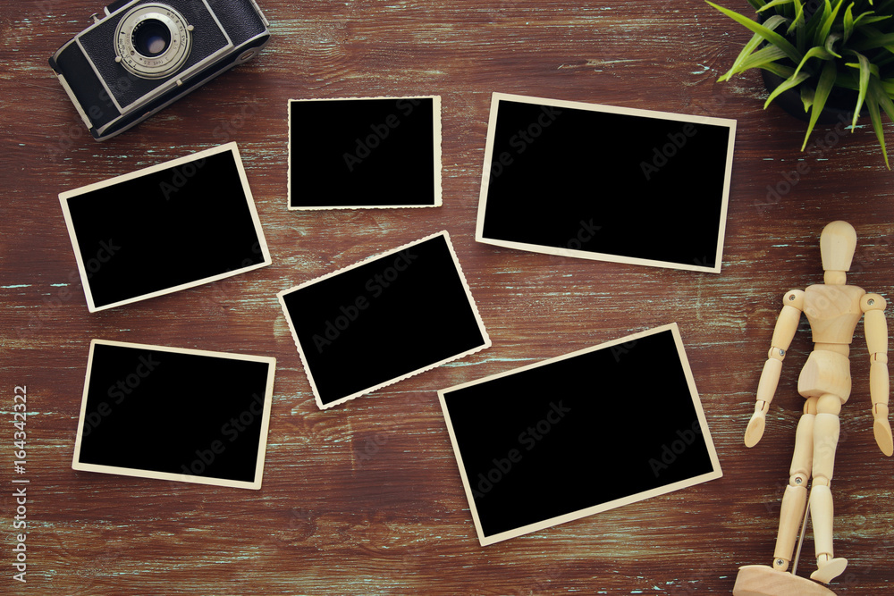 top view of blank photo frames on wooden background top view of blank photo frames on wooden background